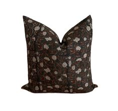 a black and brown pillow with flowers on it