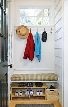 an image of a bench with shoes and hats hanging on the wall next to it