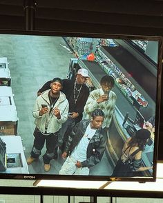 a television screen showing a group of people standing in front of a food court counter