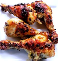 three pieces of chicken sitting on top of a white plate