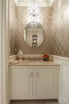 a bathroom with a vanity, mirror and lights on the wall in it's corner