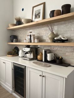 a kitchen with white cabinets and open shelves