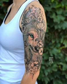 a woman with a wolf tattoo on her arm