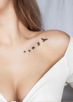 a woman's chest with birds tattoo on her left shoulder and right side breast