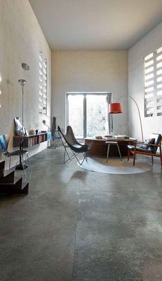 a living room filled with furniture and a large window