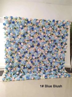 blue and pink flowers are arranged on the wall