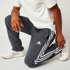 These adidas men's sweatpants were made for your comfort during workouts or lounging at home. Made from soft cotton-fleece with the brand's signature stripes and logo, these pants have an elastic-drawstring waist, side slip pockets, and a straight-leg silhouette. Style them with a t-shirt and hoodie. Front Style: Flat FrontFeatures: DrawstringClosure Type: Full Elastic, DrawstringFit: Regular FitPockets: 2 Side Slip PocketsRise: At WaistFiber Content: 78% Cotton, 22% PolyesterFabric Description… Adidas Casual Joggers With Side Stripes, Adidas Cotton Gym Pants, Adidas Athleisure Joggers For Loungewear, Adidas Cotton Sweatpants For Gym, Adidas Cotton Joggers For Gym, Adidas Sporty Relaxed Fit Joggers, Athleisure Activewear With Three Stripes For Lounging, Adidas Sweatpants For Loungewear, Athleisure Style, Adidas Sweatpants For Loungewear