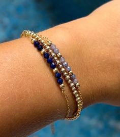 **DESCRIPTION** Delicate gold filled bracelet with micro-faceted sparkly tanzanite beads. Individually selected high quality gemstones make the bracelet truly special and one of a kind. The delicate and minimalist design goes well with both casual and sophisticated looks. Wear it by itself or stacked up with other minimalist bracelets available at the shop. **MATERIALS** - 14kt gold filled chain - 14kt gold filled clasp and chain extender (1 inch) - Tanzanite beads (approx. 3mm) **PACKAGING** All orders are packed in jewelry boxes/pouches with a brand logo, which makes it perfect for gifting. All packaging materials including mailers are eco-friendly.  **SOCIAL MEDIA** Instagram: @soellejewelry Facebook: @soellejewelry Packed with care and ready to ship!  Handmade with love ♥ Pulseras Aesthetic, Minimalist Bracelets, Tanzanite Beads, April Birthstone Necklace, Clear Quartz Necklace, June Birthstone Ring, Tanzanite Jewelry, Lapis Lazuli Bracelet, Birthstone Bracelet