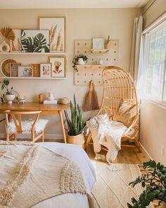 a bed room with a neatly made bed and a chair next to a desk in front of a window