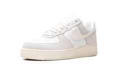 The Nike Air Force 1 Low "Sail/Platinum Tint" is a casual colorway of the retro basketball shoe with a clean appearance.  The colorway features white leather on the perforated toe and mid-panel and Platinum Tint (light grey) suede on the forefoot, collar, and heel.  A Sail leather Swoosh logo can be found on the sides.  Classic “Nike Air” and “Air Force 1” branding appear on the heel and tongue tag, respectively.  The shoe’s solid Sail rubber sole completes the look.