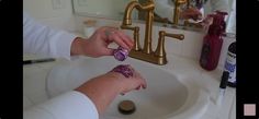 a woman is washing her hands in the bathroom sink