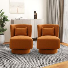 two orange chairs sitting on top of a rug