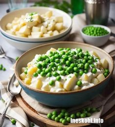 two bowls filled with peas and potatoes on top of a table