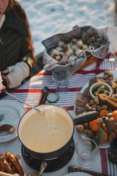 a woman is sitting at a table with food on it