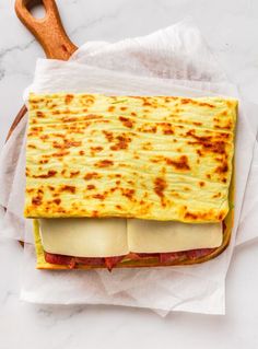 a close up of a sandwich with cheese and meat