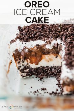 a chocolate cake with white frosting and brown sprinkles in a glass dish