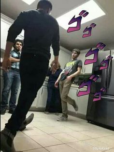 a group of young men standing around a refrigerator freezer