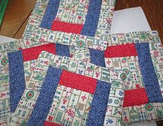 several pieces of fabric are laid out on the table to be used as quilts