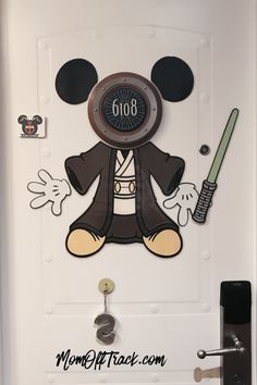 the door to mickey mouse's house is decorated with an alarm clock