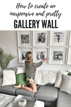 a woman sitting on top of a couch in front of a wall filled with pictures