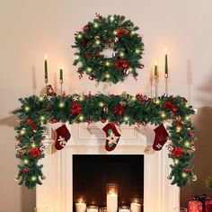 a mantel decorated with candles and christmas wreaths