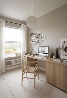 a home office with a desk and chair in front of a window