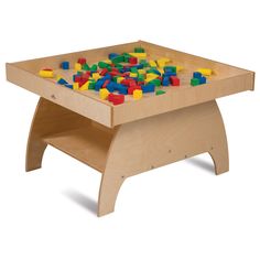 a child's wooden toy table with colored blocks on the top and bottom surface