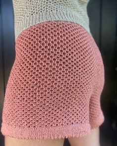 the back of a woman's shorts with pink and white crochet