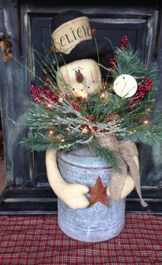 a potted planter with a snowman decoration on the top and lights in the bottom