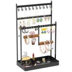 a display rack with jewelry hanging on it's sides and two shelves holding various items