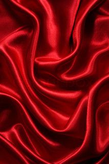 a red fabric with very long folds