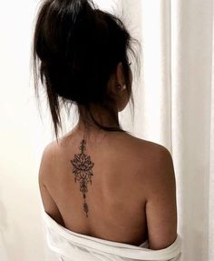 a woman with a flower tattoo on her back