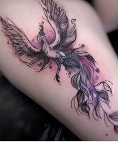 a woman's thigh with a bird tattoo on it