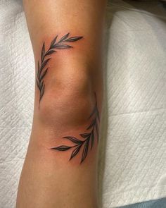 a close up of a person's leg with a tattoo design on the side