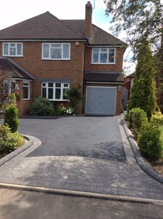 a large brick house with a driveway leading to it