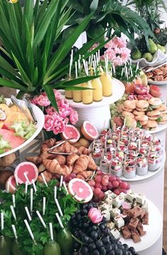 a table filled with lots of different types of foods and desserts on top of it