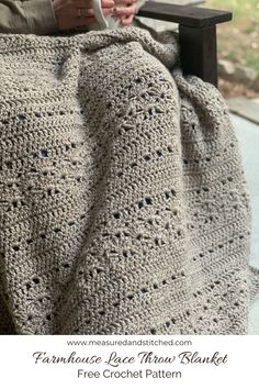 a woman sitting in a chair with a crocheted blanket on top of her