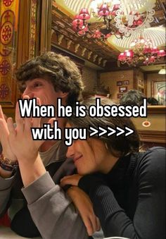 a man and woman sitting next to each other with the words when he is obsesed with you > > > >