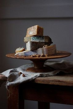 a wooden table topped with lots of different types of food on top of a plate