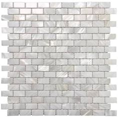 a white brick wall that is made out of glass tiles