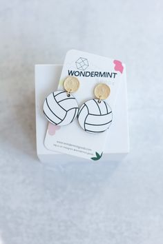 a pair of earrings that are on top of a white card with the word wondermint