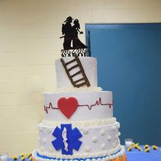 a three tiered cake decorated with medical symbols