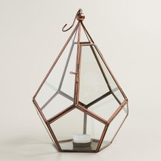 a candle holder made out of glass and metal