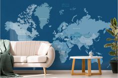 a living room with a white couch and a blue world map on the wall behind it