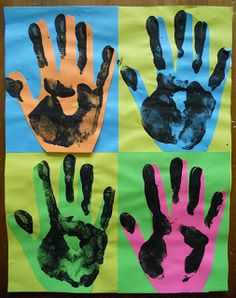 four handprints are displayed on colored paper