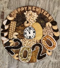 a clock made out of cookies and crackers with the words happy new year written on it