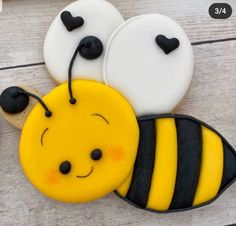 three decorated cookies in the shape of bees