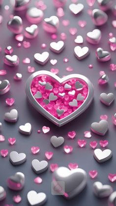 a heart shaped object surrounded by pink and silver hearts