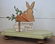 a wooden bunny sitting on top of books