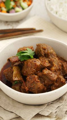 a white bowl filled with meat and vegetables